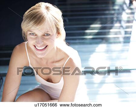Woman sitting by window looking up View Large Photo Image Stock Photograph - Woman sitting by window looking up. Fotosearch