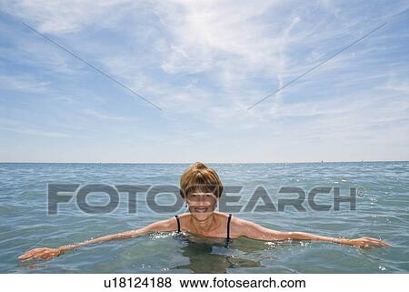 A woman in the sea smiling View Large Photo Image Stock Photo - A woman in the sea smiling. Fotosearch
