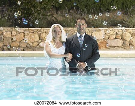 Bride and groom in pool View Large Photo Image Picture - Bride and groom in pool. Fotosearch