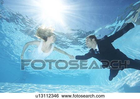 Bride and groom together in pool View Large Photo Image Stock Photograph - Bride and groom together in pool. Fotosearch