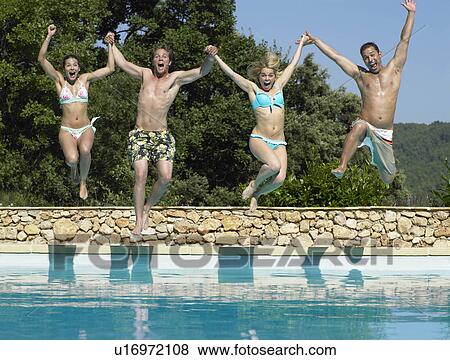 Friends jumping into pool View Large Photo Image Stock Photo - Friends jumping into pool. Fotosearch