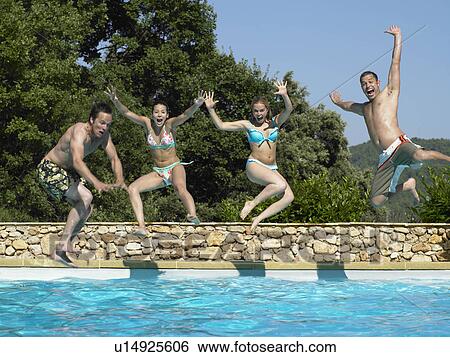 Friends jumping into swimming pool View Large Photo Image Stock Photograph - Friends jumping into swimming pool. Fotosearch
