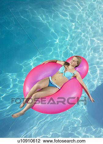 Girl asleep on inflatable chair in pool View Large Photo Image Stock Image - Girl asleep on inflatable chair in pool. Fotosearch