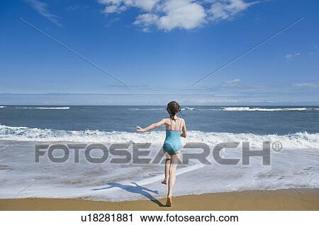 Girl running into the sea View Large Photo Image Stock Image - Girl running into the sea. Fotosearch