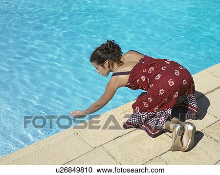 Girl testing pool water View Large Photo Image Stock Image - Girl testing pool water. Fotosearch