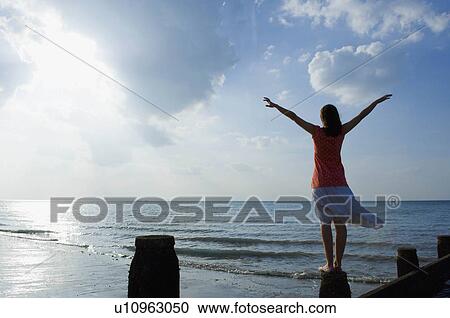 Teenage girl looking out to sea View Large Photo Image Stock Image - Teenage girl looking out to sea. Fotosearch