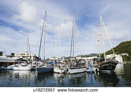 Sailboats docked at a harbor View Large Photo Image Stock Photo - Sailboats docked at a harbor. Fotosearch
