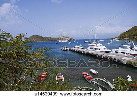 Stock Photo - Boats moored near a pier in the sea. Fotosearch