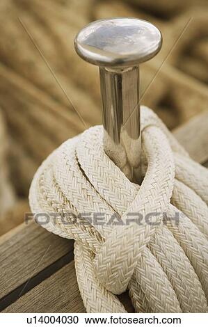 Close-up of a peg and a rope on the deck of a sailboat View Large Photo Image Stock Image - Close-up of a peg and a rope on the deck of a sailboat. Fotosearch