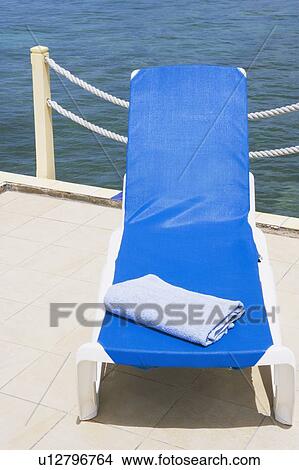 High angle view of a towel on a lounge chair View Large Photo Image Picture - High angle view of a towel on a lounge chair. Fotosearch