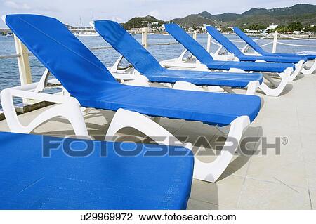 Stock Image - Lounge chairs in a row. Fotosearch