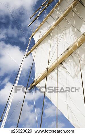 Low angle view of sails of a sailing ship View Large Photo Image Stock Photo - Low angle view of sails of a sailing ship. Fotosearch