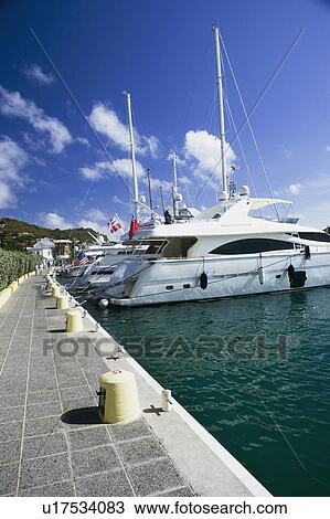 Sailboats moored at a harbor View Large Photo Image Stock Image - Sailboats moored at a harbor. Fotosearch