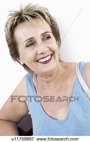 Close-up of a mature woman smiling View Large Photo Image Stock Photo - Close-up of a mature woman smiling. Fotosearch