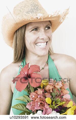 Close-up of a mid adult woman holding a bouquet of flowers View Large Photo Image Stock Image - Close-up of a mid adult woman holding a bouquet of flowers. Fotosearch