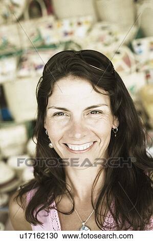 Stock Image - Close-up of a mid adult woman smiling. Fotosearch