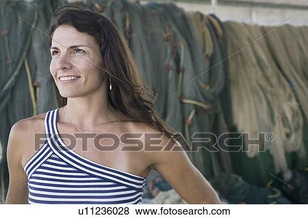 Stock Photo - Close-up of a mid adult woman smiling. Fotosearch