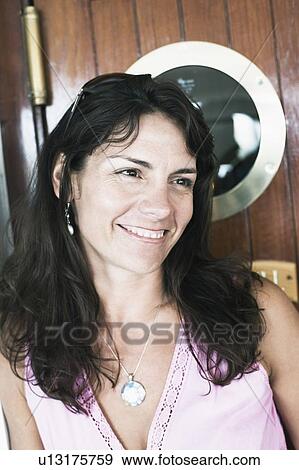 Close-up of a mid adult woman smiling View Large Photo Image Stock Photo - Close-up of a mid adult woman smiling. Fotosearch