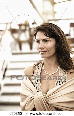 Mid adult woman on a sailing ship and smiling View Large Photo Image Picture - Mid adult woman on a sailing ship and smiling. Fotosearch