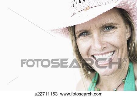 Stock Image - Portrait of a mid adult woman smiling. Fotosearch