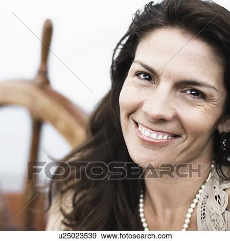 Stock Photo - Portrait of a mid adult woman smiling. Fotosearch