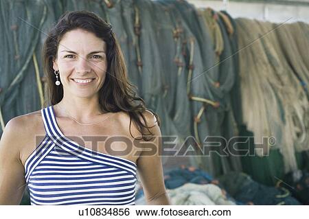 Stock Photograph - Portrait of a mid adult woman smiling. Fotosearch