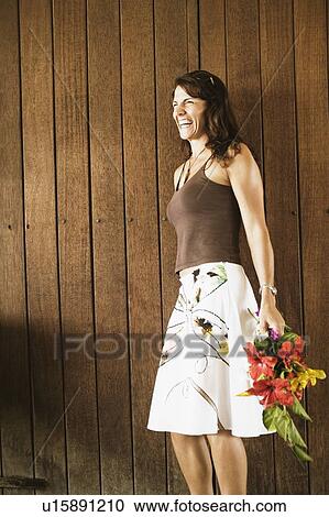 Side profile of a mid adult woman holding a bouquet of flowers View Large Photo Image Stock Image - Side profile of a mid adult woman holding a bouquet of flowers. Fotosearch