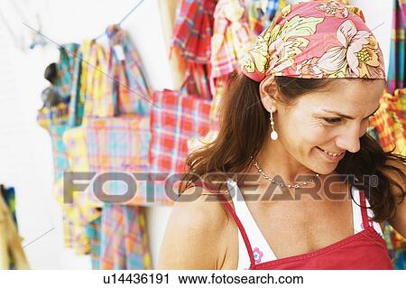 Close-up of a mid adult woman at a market stall and smiling View Large Photo Image Stock Image - Close-up of a mid adult woman at a market stall and smiling. Fotosearch