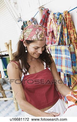 Close-up of a mid adult woman at a market stall and smiling View Large Photo Image Stock Image - Close-up of a mid adult woman at a market stall and smiling. Fotosearch