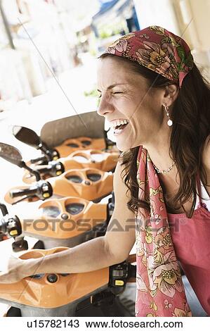 Stock Image - Close-up of a mid adult woman smiling. Fotosearch