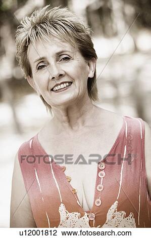 Portrait of a mature woman smiling View Large Photo Image Stock Image - Portrait of a mature woman smiling. Fotosearch
