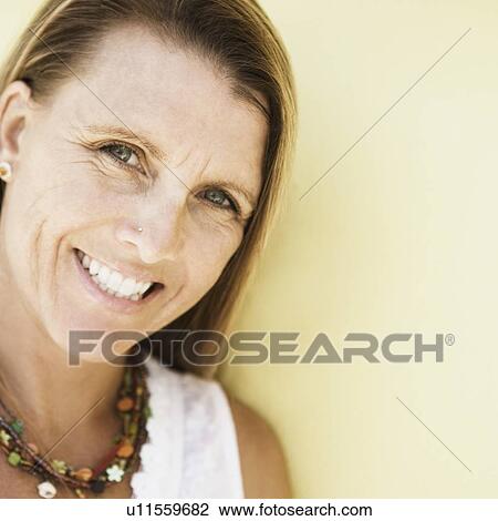 Portrait of a mid adult woman holding a digital camera and smiling View Large Photo Image Stock Image - Portrait of a mid adult woman holding a digital camera and smiling. Fotosearch