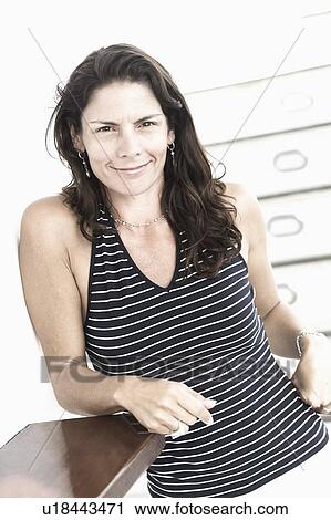 Portrait of a mid adult woman smirking View Large Photo Image Stock Image - Portrait of a mid adult woman smirking. Fotosearch