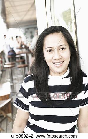 Portrait of a young woman smiling View Large Photo Image Stock Image - Portrait of a young woman smiling. Fotosearch