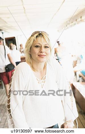Stock Photo - Portrait of a young woman smirking. Fotosearch