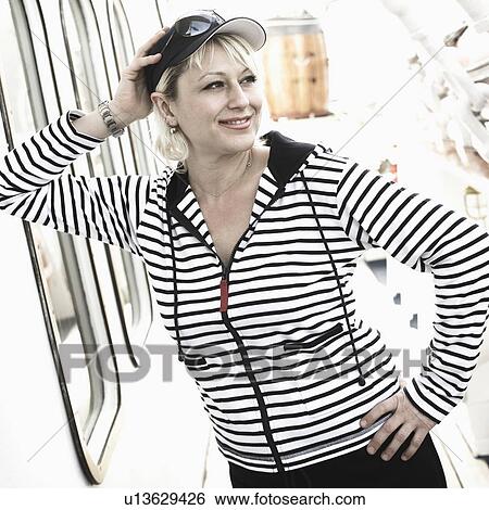 Young woman smiling with her hands on her hip on the deck of a cruise ship View Large Photo Image Stock Photograph - Young woman smiling with her hands on her hip on the deck of a cruise ship. Fotosearch