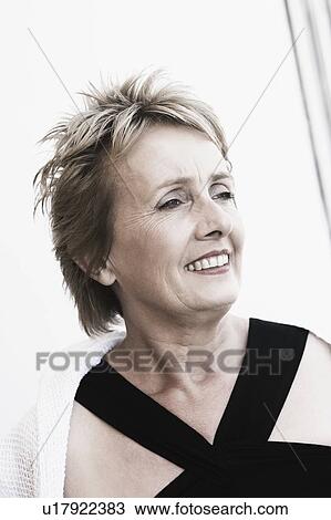 Close-up of a mature woman smiling View Large Photo Image Stock Image - Close-up of a mature woman smiling. Fotosearch