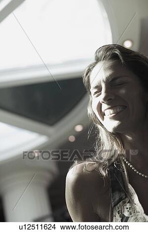 Close-up of a mid adult woman smiling View Large Photo Image Picture - Close-up of a mid adult woman smiling. Fotosearch