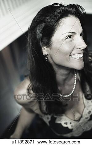 Close-up of a mid adult woman smiling View Large Photo Image Stock Image - Close-up of a mid adult woman smiling. Fotosearch