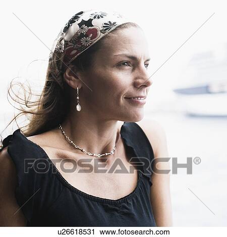 Close-up of a mid adult woman smiling View Large Photo Image Stock Image - Close-up of a mid adult woman smiling. Fotosearch