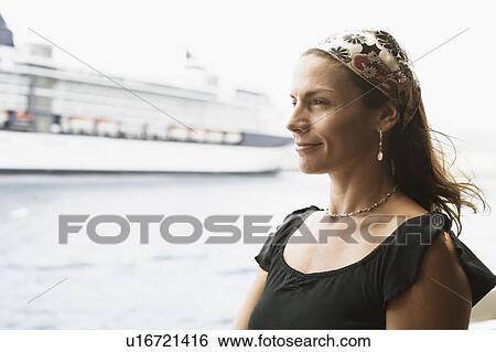 Stock Photograph - Close-up of a mid adult woman smiling. Fotosearch