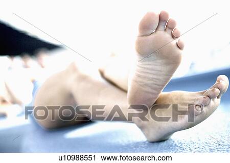 Low section view of a woman lying on the ledge of a swimming pool View Large Photo Image Stock Image - Low section view of a woman lying on the ledge of a swimming pool. Fotosearch