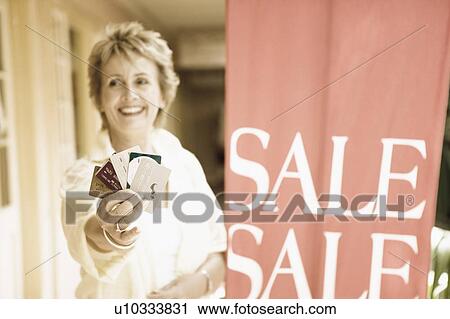 Mature woman showing credit cards and smiling View Large Photo Image Stock Image - Mature woman showing credit cards and smiling. Fotosearch