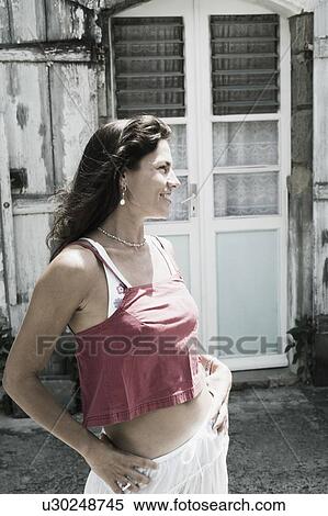 Mid adult woman standing with arms akimbo and smiling View Large Photo Image Stock Photography - Mid adult woman standing with arms akimbo and smiling. Fotosearch