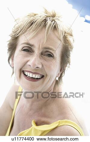Portrait of a mature woman smiling View Large Photo Image Stock Image - Portrait of a mature woman smiling. Fotosearch