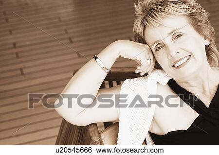 Portrait of a mature woman smiling View Large Photo Image Stock Photograph - Portrait of a mature woman smiling. Fotosearch