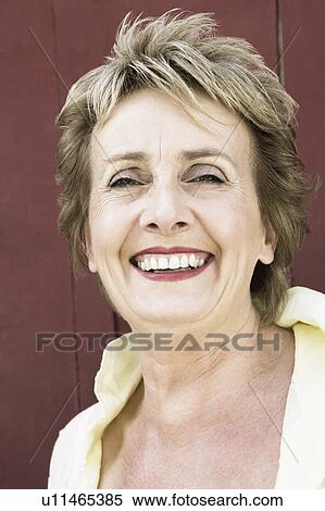Portrait of a mature woman smiling View Large Photo Image Stock Photography - Portrait of a mature woman smiling. Fotosearch