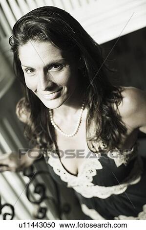Portrait of a mid adult woman smiling View Large Photo Image Stock Image - Portrait of a mid adult woman smiling. Fotosearch