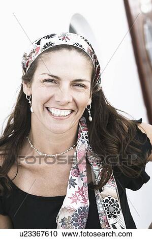 Stock Image - Portrait of a mid adult woman smiling. Fotosearch