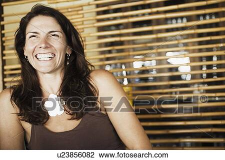 Close-up of a mid adult woman smiling View Large Photo Image Stock Image - Close-up of a mid adult woman smiling. Fotosearch